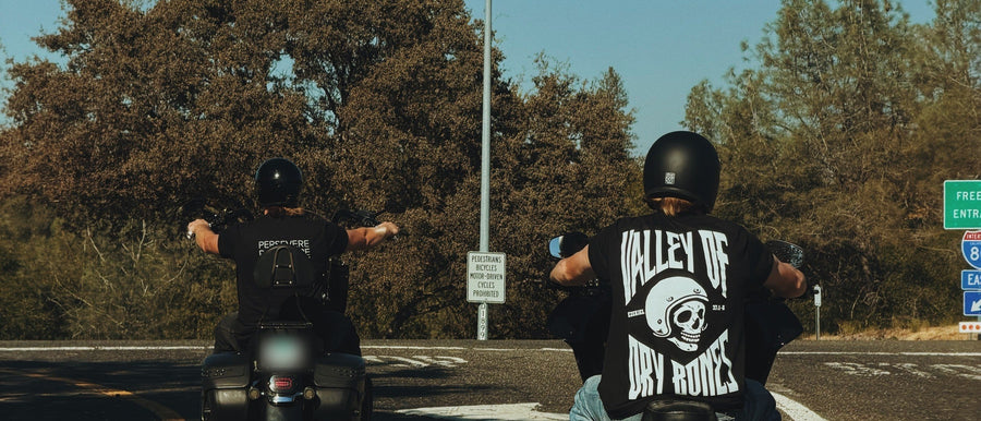 Two riders on the back roads of Northern California, one in the Valley of Dry Bones tee